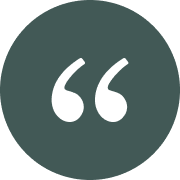 White quotation marks icon on a dark circular background.