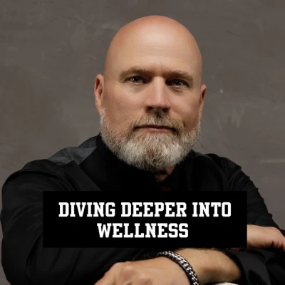 A bald man with a beard poses with text about wellness.